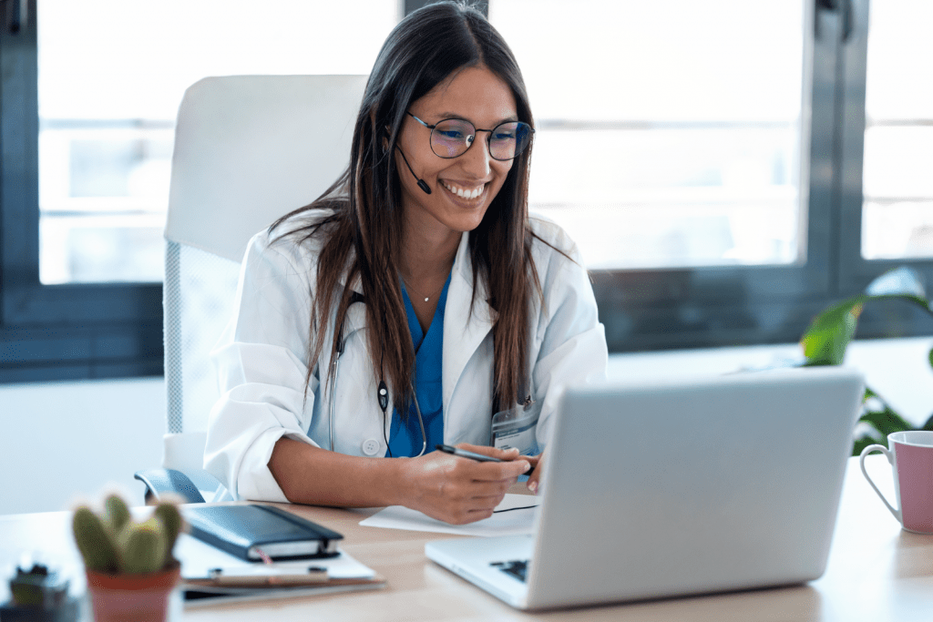 Female Doctor Talking With Patient Through A Video consultation on Laptop 