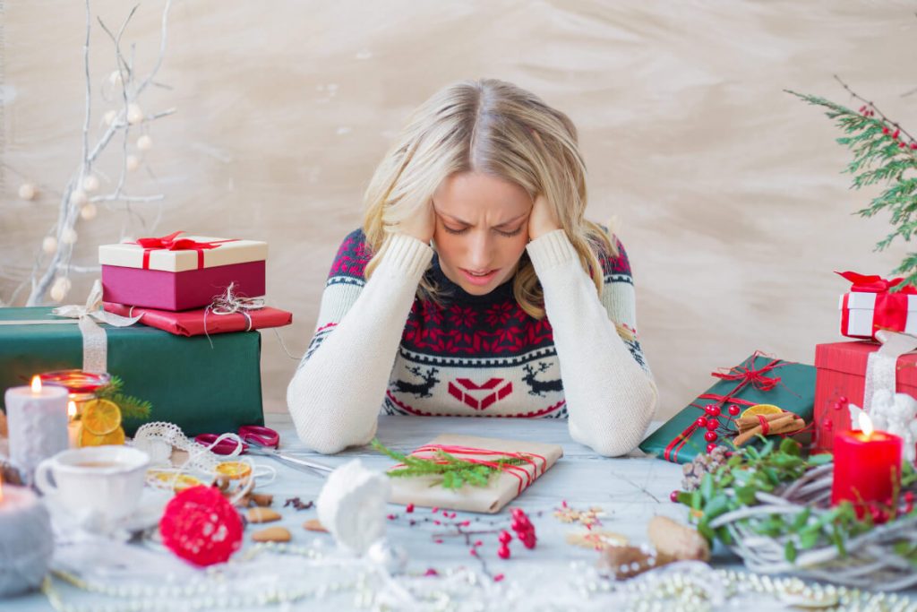 Blonde female trying to handle stress at Christmas